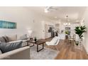 Bright, open-concept living room featuring modern furniture, hardwood floors, and neutral decor at 3940 E Heather Ct, Gilbert, AZ 85234