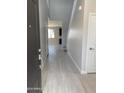 Inviting entryway showcasing wood-look tile flooring, and a staircase leading to the upper level at 4924 W Brown St, Glendale, AZ 85302