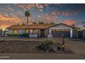 Beautiful home featuring desert landscaping, a two-car garage, and a covered porch, perfect for relaxed living at 5101 E Paradise Dr, Scottsdale, AZ 85254