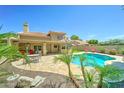Backyard featuring a sparkling swimming pool with lush landscaping and an outdoor dining area at 5431 E Piping Rock Rd, Scottsdale, AZ 85254