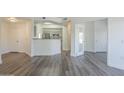 Bright living room with open floor plan, fireplace, and modern gray wood-look floors at 600 W Grove Pkwy # 2188, Tempe, AZ 85283