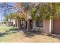 Street view of multiple townhouses and grassy yards, all shaded by trees at 7126 N 19Th Ave # 152, Phoenix, AZ 85021
