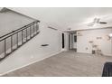 Bright living room features tile floors, fan, stairs, and neutral color scheme at 7126 N 19Th Ave # 152, Phoenix, AZ 85021