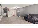 Open-concept living room with gray walls, tile floors, and a cozy gray sofa at 7126 N 19Th Ave # 152, Phoenix, AZ 85021