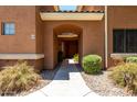 Inviting covered entrance with archway, tiled ceiling, and well-maintained landscaping, offering a warm welcome at 955 E Knox Rd # 126, Chandler, AZ 85225