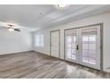 Bright living room boasts wood-look flooring and double doors to the patio at 14644 N Yerba Buena Way # C, Fountain Hills, AZ 85268