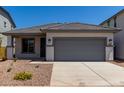 Charming single-story home with gray trim, a gray garage door, and desert landscaping at 17032 W Cavedale Dr, Surprise, AZ 85387