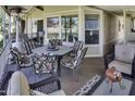 Relaxing covered patio with an outdoor dining table and view of palm trees and the golf course at 17200 W Bell Rd # 1602, Surprise, AZ 85374