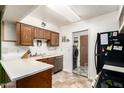 Efficient kitchen with laminate countertops and wooden cabinets, complete with appliances and adjacent laundry area at 1807 E Jamaica Ave, Mesa, AZ 85204