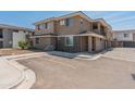 Neutral-toned home showcasing stonework accents, well-maintained landscaping, and convenient parking at 2121 W Sonoran Desert Dr # 14, Phoenix, AZ 85085