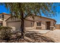 Charming single-story home with desert landscaping, an attached garage, and a cozy front porch entrance at 2516 E San Manuel Rd, San Tan Valley, AZ 85143