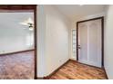 Elegant foyer with hardwood floors and decorative front door with sidelight window at 2602 S 226Th Dr, Buckeye, AZ 85326