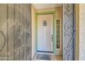 Charming front door with decorative screen door and welcome mat at 2602 S 226Th Dr, Buckeye, AZ 85326