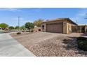 This house has a well manicured yard with decorative rock and a two car garage at 2670 E Bellerive Dr, Gilbert, AZ 85298