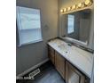 Bathroom with a modern vanity, decorative mirror, updated lighting and mosaic backsplash at 318 N Pinal Dr, Apache Junction, AZ 85120