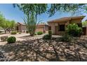Well-maintained home with desert landscaping, mature trees, and a two-car garage at 35729 N 32Nd Ave, Phoenix, AZ 85086
