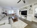 Bright living room featuring a plush gray sectional sofa, modern built-ins, and stylish decor, perfect for relaxing at 4050 E Cactus Rd # 107, Phoenix, AZ 85032