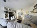 Inviting living space with a large sectional sofa, contemporary shelving, and seamless flow into the kitchen area at 4050 E Cactus Rd # 107, Phoenix, AZ 85032