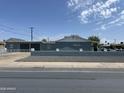 Side view of a well maintained home with a painted gray exterior and block wall at 4502 N 50Th Ave, Phoenix, AZ 85031