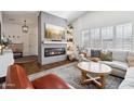 Stylish living room featuring a fireplace, large screen TV, and a comfortable neutral-toned sectional at 4525 N 66Th St # 1, Scottsdale, AZ 85251