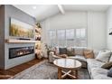 Bright and airy living room featuring a fireplace, large screen TV, and a comfortable neutral-toned sectional at 4525 N 66Th St # 1, Scottsdale, AZ 85251