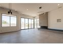 Contemporary living room with a sleek fireplace, modern lighting, and large windows for natural light at 5145 N Ascent Dr, Scottsdale, AZ 85251