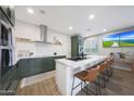 Beautiful kitchen with stainless appliances, a kitchen island with barstools and pendant lighting at 5439 W Odeum Ln, Phoenix, AZ 85043