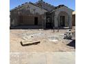 Under construction: a single-Gathering home shows exposed stucco, a two-car garage, and arched porch, ready for personalization at 6015 E Artemis Dr, Florence, AZ 85132
