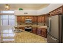Kitchen with wood cabinets, granite countertops and stainless steel appliances at 760 N Swallow Ln, Gilbert, AZ 85234