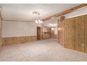Spacious living room featuring wood paneling, neutral carpet and plenty of space for entertaining at 8103 E Southern Ave # 69, Mesa, AZ 85209