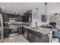 Modern kitchen featuring granite countertops, stainless steel appliances, and stylish dark wood cabinets at 8415 W Coolidge St, Phoenix, AZ 85037