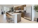 Modern kitchen with a spacious island, stainless steel appliances, and ample counter space at 9621 W Monterey Way, Phoenix, AZ 85037