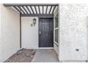 Inviting entryway with pergola, security door, and textured exterior at 1051 S Dobson Rd # 67, Mesa, AZ 85202