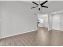Bright living room featuring wood-look tile flooring, neutral walls, and a modern ceiling fan at 1051 S Dobson Rd # 67, Mesa, AZ 85202