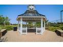 Community gazebo with a clock tower, offering a shaded area for relaxation and gatherings at 10538 E Naranja Ave, Mesa, AZ 85209