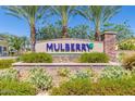 Mulberry community entrance sign with lush landscaping and decorative stone accents at 10538 E Naranja Ave, Mesa, AZ 85209