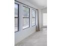Bright hallway featuring neutral tile flooring, white walls, and natural light pouring through the large windows at 10613 S 41St Pl, Phoenix, AZ 85044