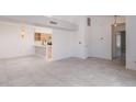 Open-concept living area with tile flooring, white walls, and a view into the kitchen and dining space at 10613 S 41St Pl, Phoenix, AZ 85044