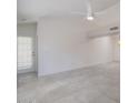 Spacious living room featuring tile flooring, white walls, access to the outdoors, and a ceiling fan at 10613 S 41St Pl, Phoenix, AZ 85044