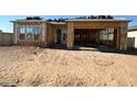New home under construction with a partial roof and visible wood framework for windows and garage at 11410 E Utah Ave, Mesa, AZ 85212