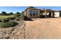 A new construction house showing the framing and construction of the garage, walls, and the yard filled with dirt at 11410 E Utah Ave, Mesa, AZ 85212