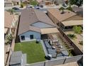 Spacious backyard featuring a covered patio, low maintenance landscaping, a storage shed, and a block fence at 11601 W Bloomfield Rd, El Mirage, AZ 85335