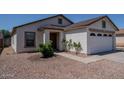 Charming single-story home featuring a two-car garage, neutral paint, and low maintenance desert landscaping at 11601 W Bloomfield Rd, El Mirage, AZ 85335