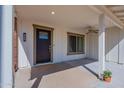 Charming front porch with a ceiling fan and dark wood door at 12234 S Pewaukee St, Phoenix, AZ 85044
