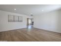 Bright living room featuring hardwood floors, recessed lighting, and neutral wall color with artwork at 12234 S Pewaukee St, Phoenix, AZ 85044