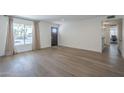 Open-concept living room with modern flooring, large window, and access to the rest of the house at 12234 S Pewaukee St, Phoenix, AZ 85044