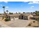 Aerial view of a charming single-Gathering home with desert landscaping and a three car garage at 14621 W Catalina Dr, Goodyear, AZ 85395