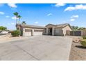 Charming home featuring a desert landscape, a wide driveway and a three car garage at 14621 W Catalina Dr, Goodyear, AZ 85395