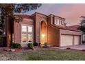 Inviting two-story house showcasing an arched entryway and lush landscaping at twilight at 1521 W Kent Dr, Chandler, AZ 85224