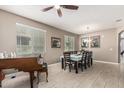 Bright dining room with elegant tile flooring, ceiling fan, and a formal dining table for eight guests at 1723 N Hillcrest --, Mesa, AZ 85201